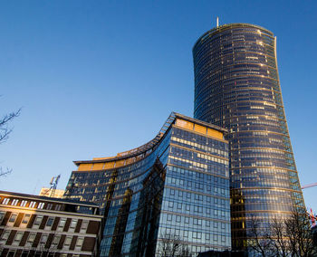 Low angle view of modern building against clear blue sky