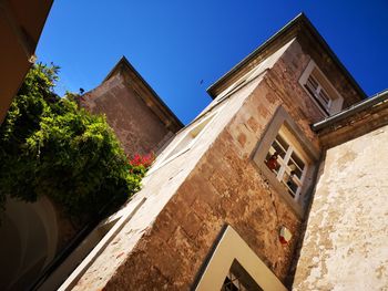 Low angle view of building against clear blue sky