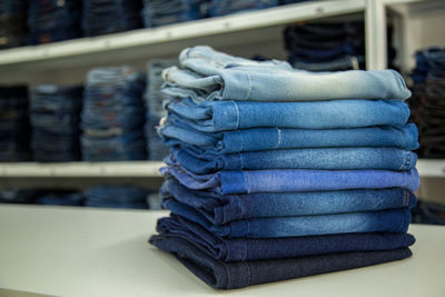 Stack of jeans on table