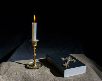 High angle view of illuminated candles on table