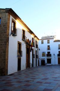 View of buildings in city against clear sky