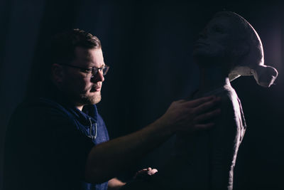 Sculptor making statue at workshop