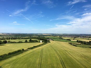 Scenic view of field against blue sky