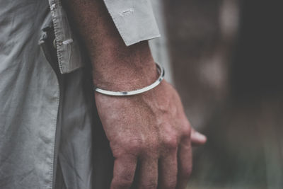 Midsection of man wearing bracelet