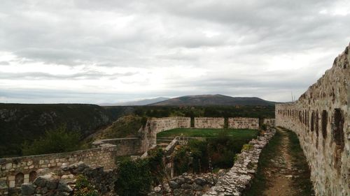 Scenic view of mountain against cloudy sky