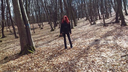 Full length of woman standing in forest