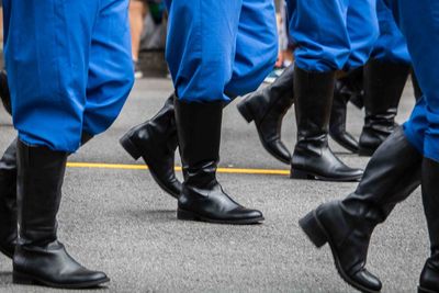 Low section of people in parade walking on street