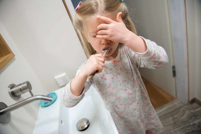 Midsection of woman in bathroom at home