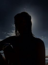 Portrait of silhouette woman standing against sky
