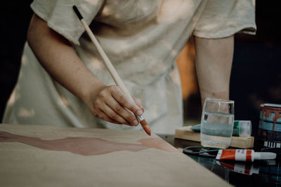 Midsection of man working on table