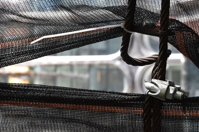 Close-up of rope tied to railing