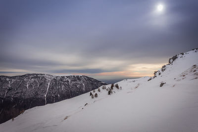 Scenic view of snow covered mountains against sky