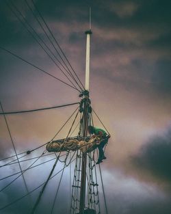 Low angle view of ship against cloudy sky