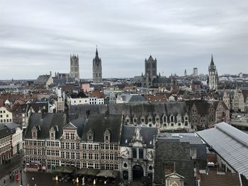 High angle view of city buildings against cloudy sky gent belgium gravensteen