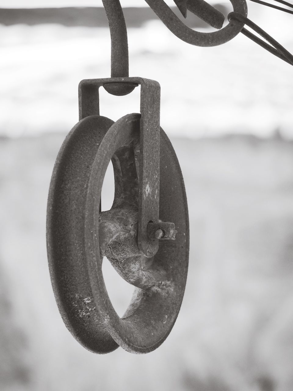 CLOSE-UP OF RUSTY CHAIN HANGING ON METAL STRUCTURE