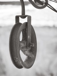Close-up of metal chain hanging on metallic structure