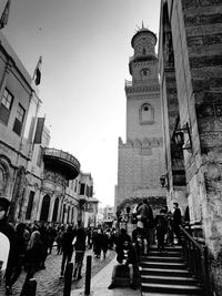 Low angle view of people walking in city