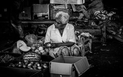 Full length of man sitting at market