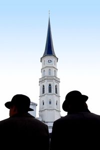 Men with tower in background