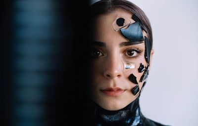 Close-up portrait of a beautiful young woman with shattered broken glass