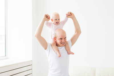 Father carrying daughter on shoulders