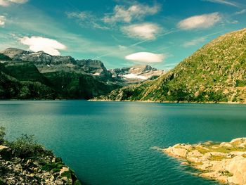 Scenic view of lake and mountains against sky