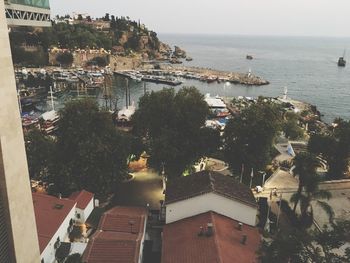 High angle view of townscape by sea against sky