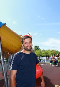 Portrait of young man standing against sky