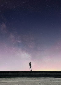 Woman standing against star field