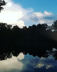 Low angle view of silhouette trees against sky