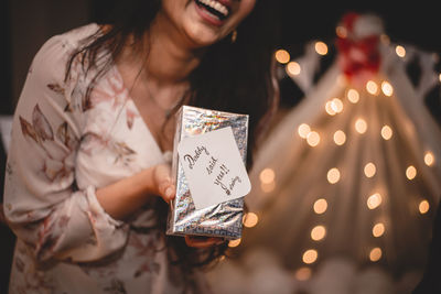 Woman holding umbrella at night