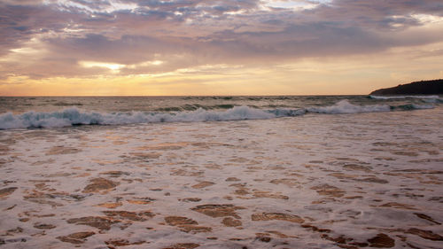 Scenic view of beach against sky during sunset