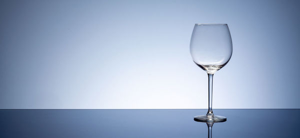 Close-up of glass of water against blue background