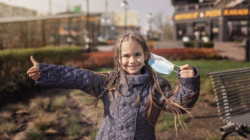 Portrait of smiling girl standing outdoors