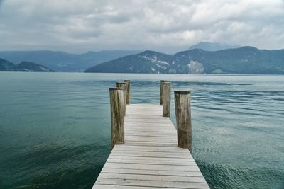 Wooden pier over sea against sky