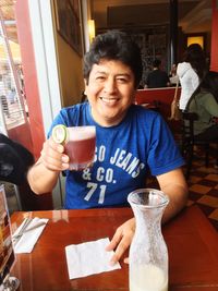 Young man drinking coffee at restaurant