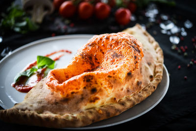Close-up of pizza served on plate