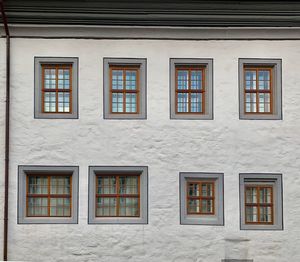 Low angle view of windows on wall of building