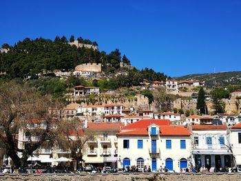 Buildings in town against clear blue sky