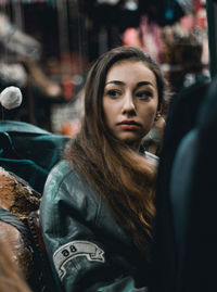 Close-up of young woman with long hair in city