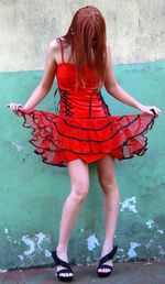 Young girl in red minidress