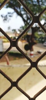 Close-up of chainlink fence against sky