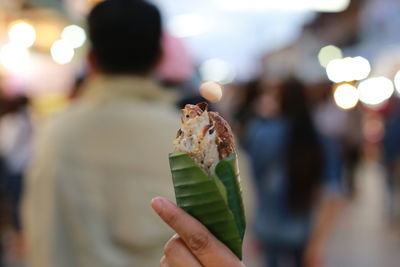 Cropped image of hand holding ice cream