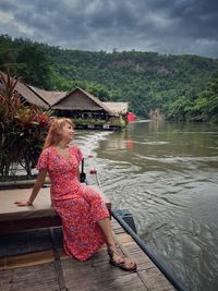 Asian woman enjoy her vacation on rafting houses in kanchanaburi, thailand 