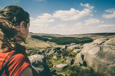 Rear view of woman standing on landscape