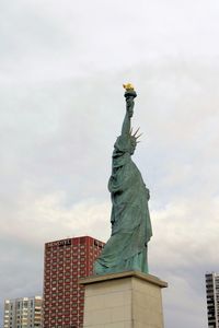 Low angle view of statue against cloudy sky