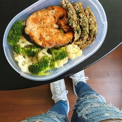 Low section of woman standing by food on table