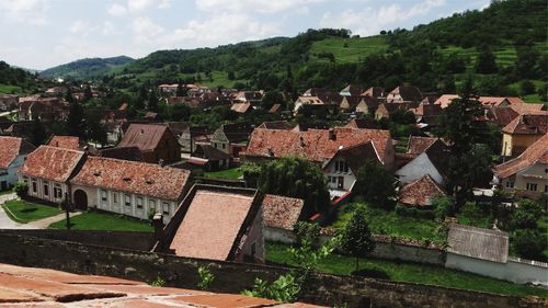 Houses in town against sky