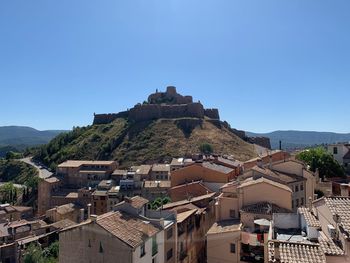 Townscape against clear blue sky