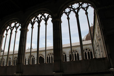 Low angle view of historic building seen through window